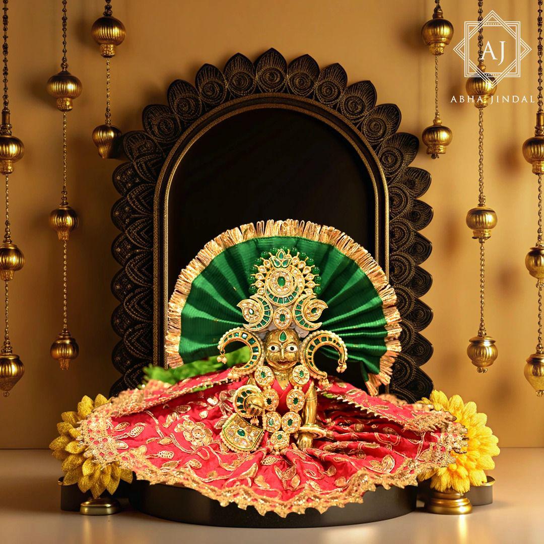 Deity dressed in an emerald-green and red shringar presentation.