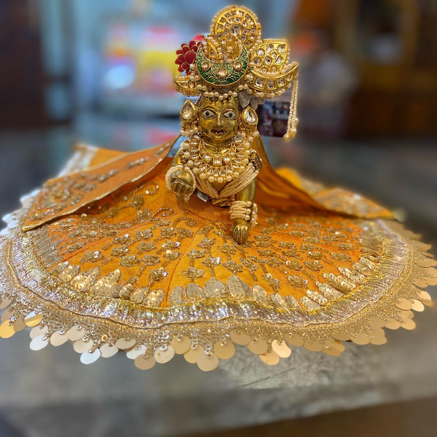 Gold and Orange Deity Poshak and Shringar, a poshak & shringar piece.