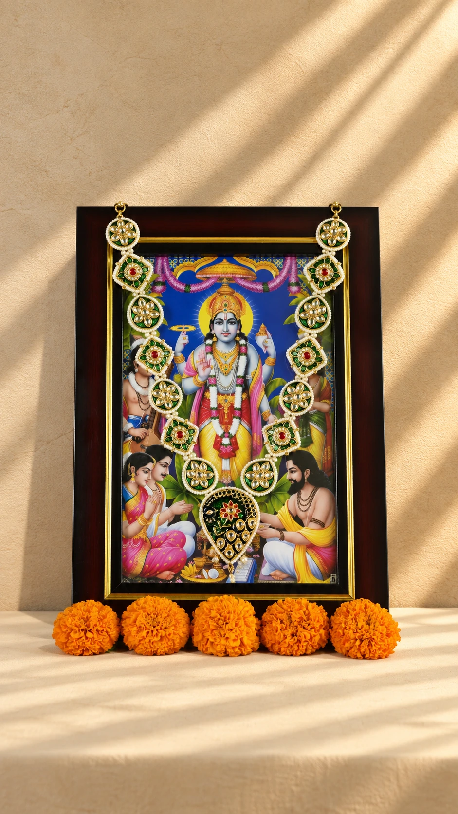 Green floral medallion photo mala with ivory bead edging and a teardrop centrepiece, styled on a framed devotional image.
