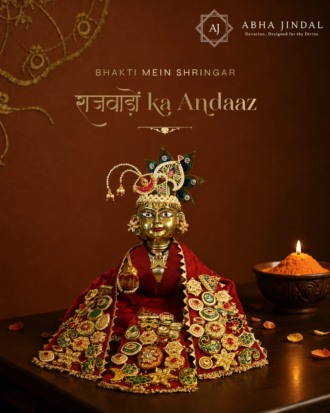 Laddu Gopal in a richly decorated red Rajwada poshak with layered panels, colourful floral motifs and a peacock-style mukut.
