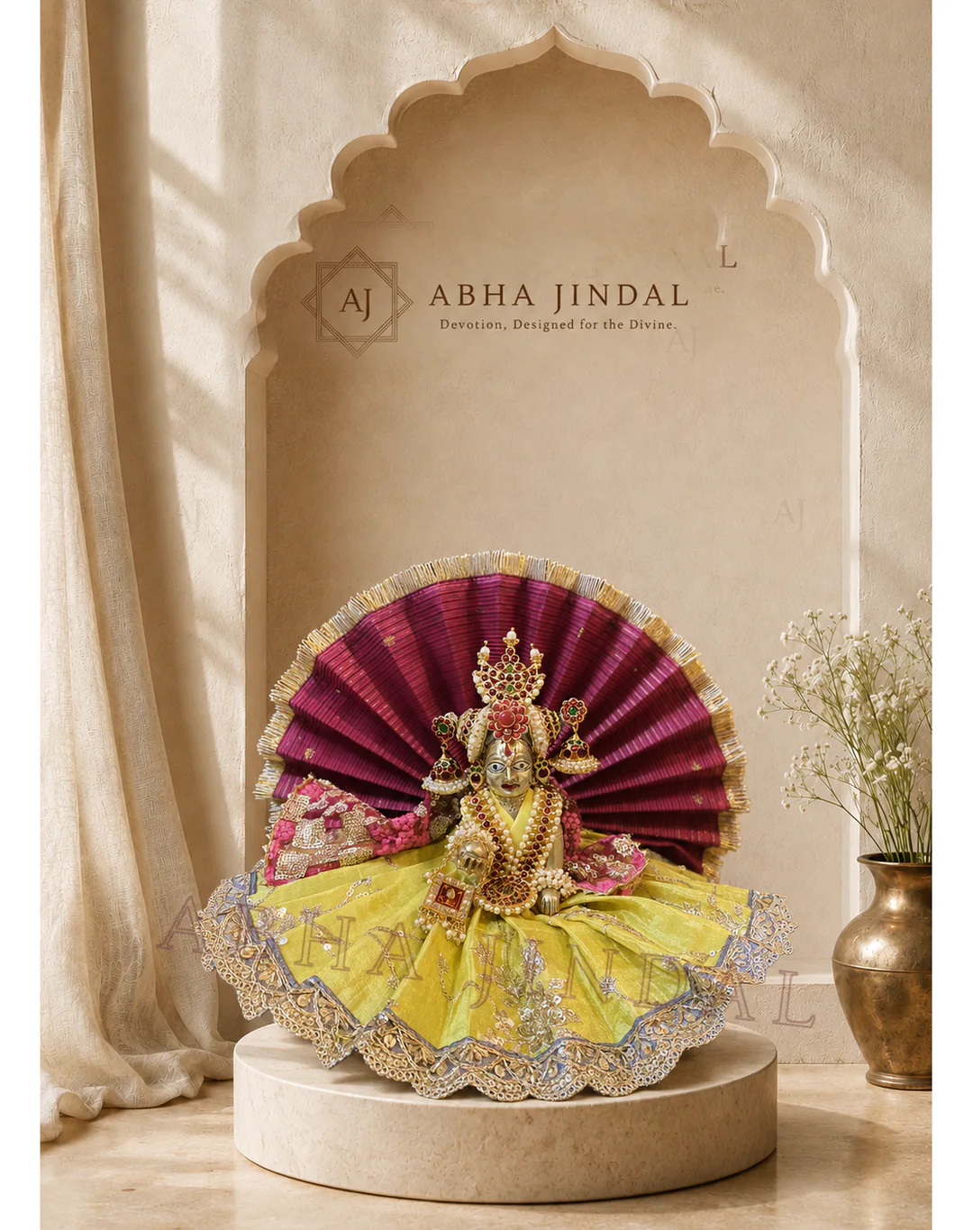 Laddu Gopal in a lime-yellow layered poshak before a maroon fan halo in an ivory-toned alcove