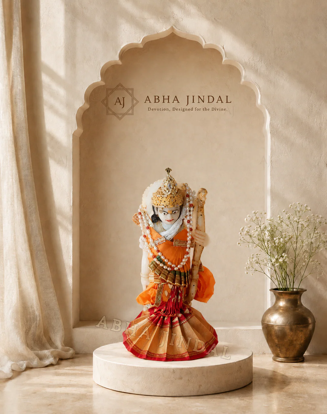 Saraswati Ji in saffron-red tiered shringar with pearl-white bead strands, gold-tone accents and a tall crown