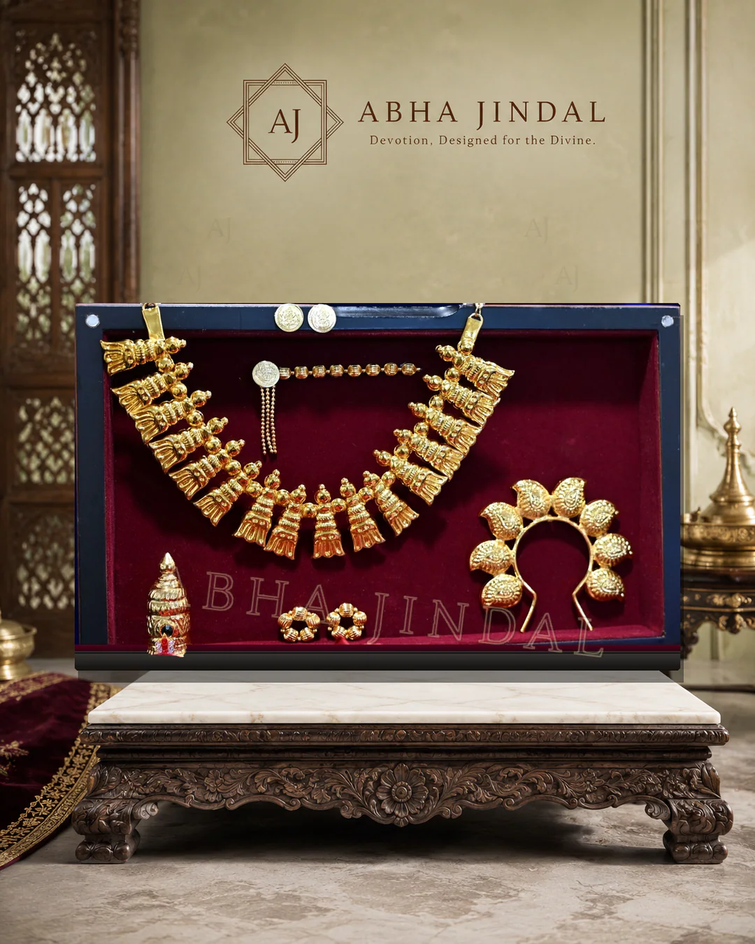 Gold-tone and pearl-white God Jewellery arranged in a deep red presentation case