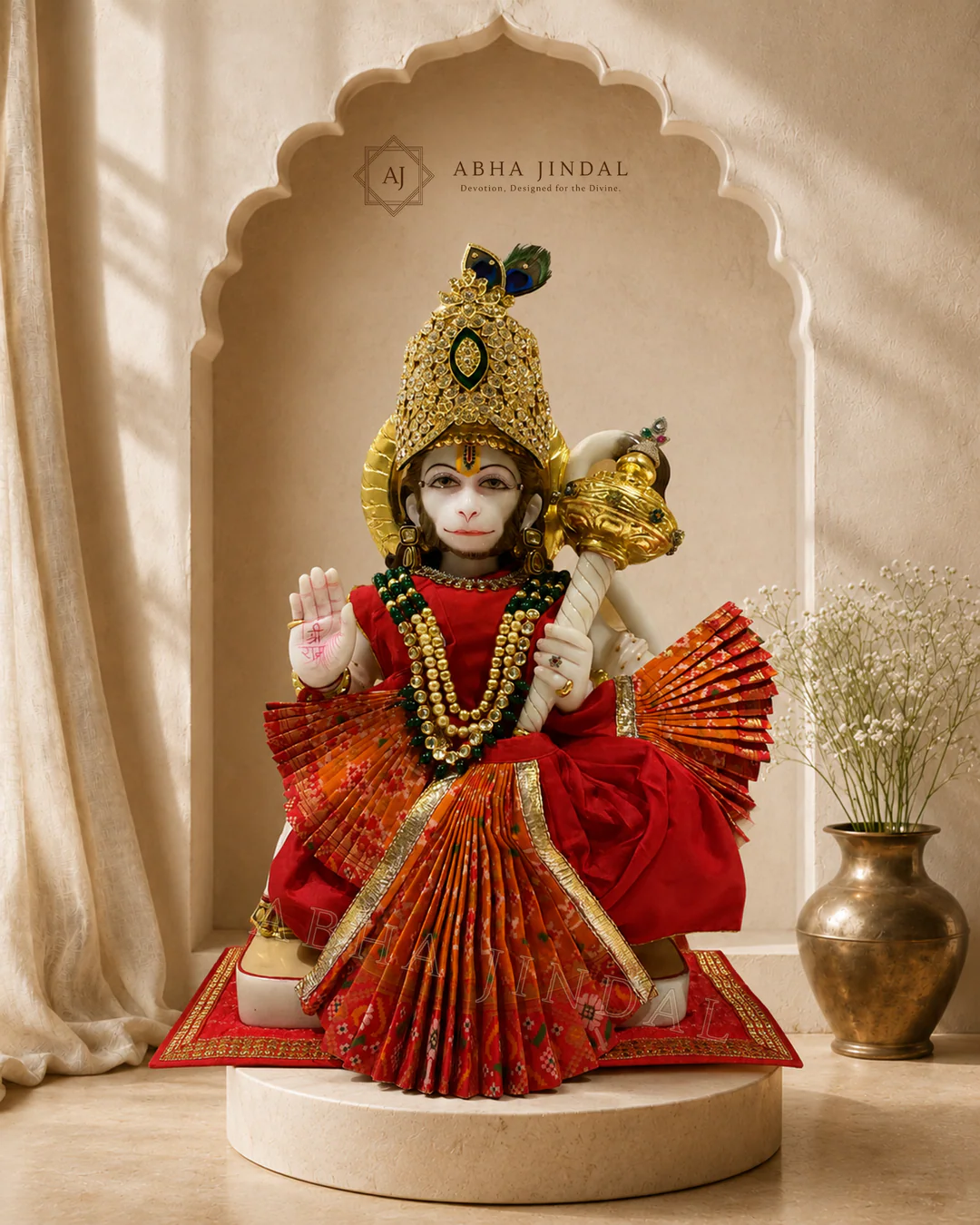 Standing Hanuman Ji in red and black attire with a pleated base, tall crown and mace