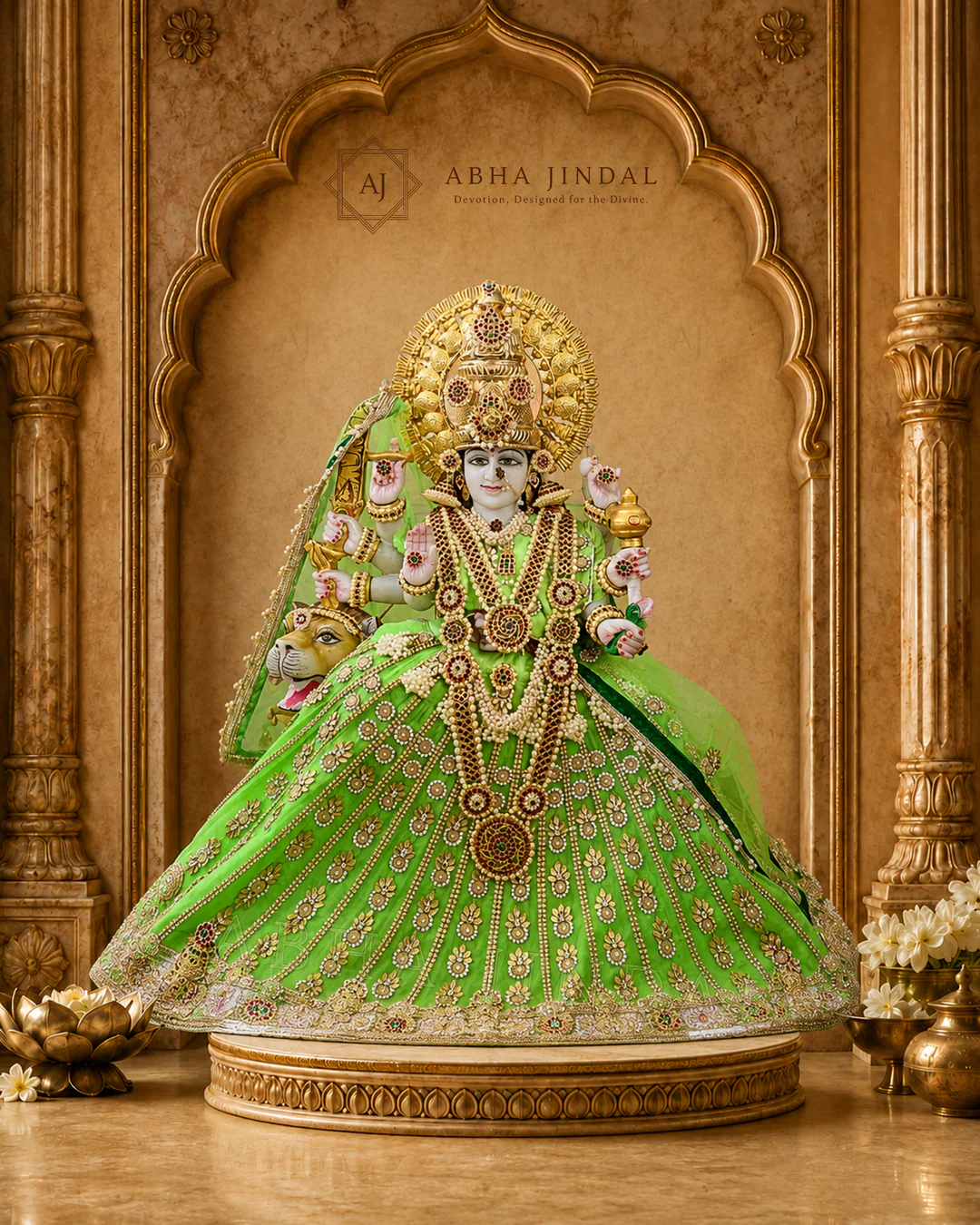 Mata Rani in emerald green attire with ruby-red accents, a tall crown and wide ceremonial skirt